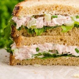 close up side shot of the layers of tuna sandwich stacked on top of each other
