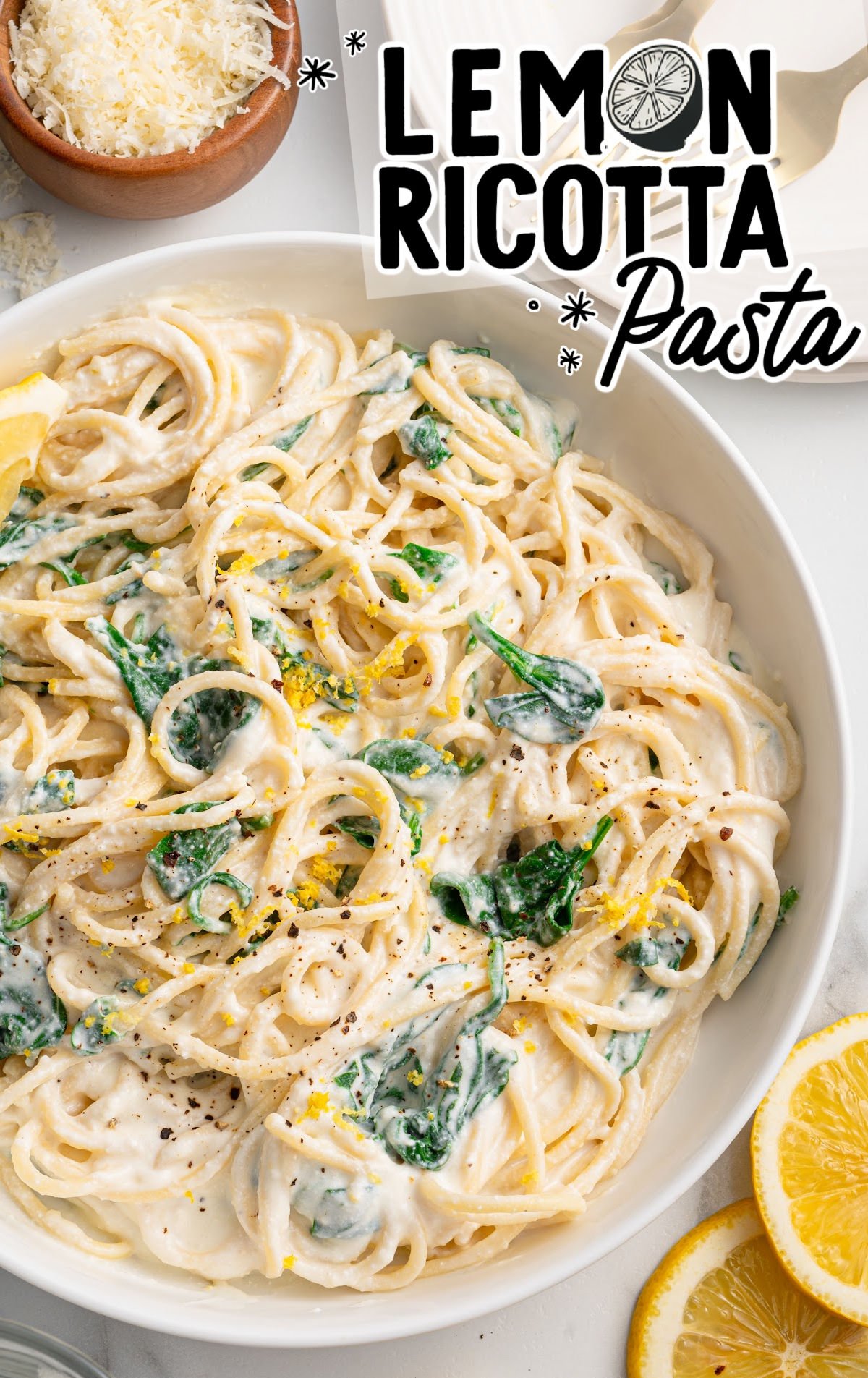 lemon ricotta pasta with spinach, topped with lemon zest and black pepper.